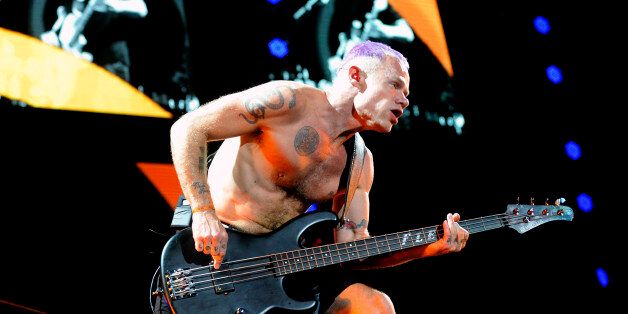 Musician Michael 'Flea' Balzary, of Red Hot Chili Peppers performs onstage during a show in Asuncion, Paraguay on November 5, 2013. AFP PHOTO / Norberto Duarte (Photo credit should read NORBERTO DUARTE/AFP/Getty Images)