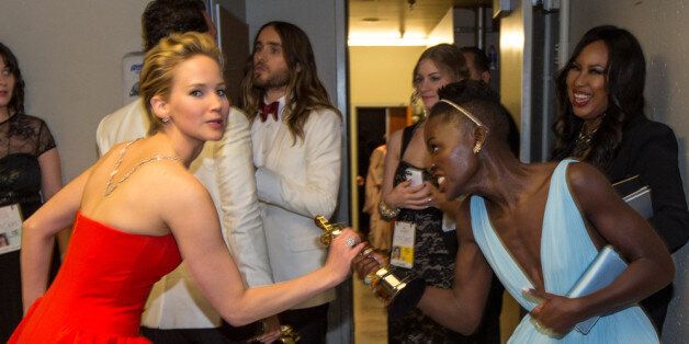 HOLLYWOOD, CA - MARCH 02: Actresses Jennifer Lawrence (L) and Lupita Nyong'o backstage during the Oscars held at Dolby Theatre on March 2, 2014 in Hollywood, California. (Photo by Christopher Polk/Getty Images)