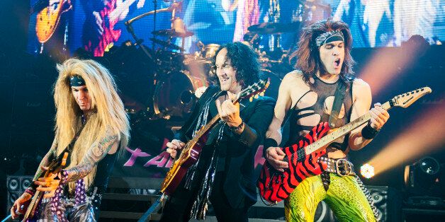 LONDON, UNITED KINGDOM - NOVEMBER 15: (L-R) Lexxi Foxxx of Steel Panther, Vivian Campbell of Def Leppard and Satchel of Steel Panther perform at Hammersmith Apollo on November 15, 2012 in London, United Kingdom. (Photo by Neil Lupin/Redferns via Getty Images)