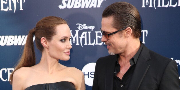 Angelina Jolie and Brad Pitt arrive at the world premiere of "Maleficent" at the El Capitan Theatre on Wednesday, May 28, 2014, in Los Angeles. (Photo by Matt Sayles/Invision/AP)