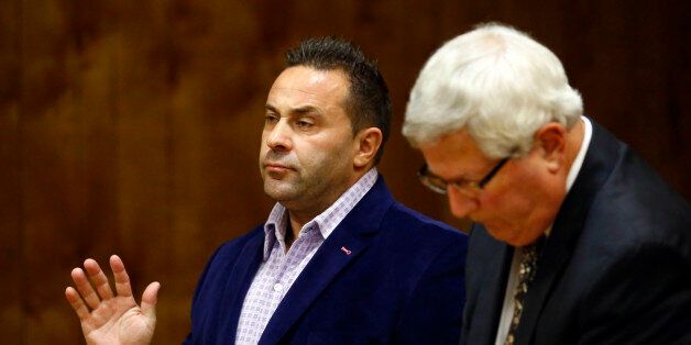 Giuseppe "Joe" Giudice, from the television show "Real Housewives of New Jersey", listens during a hearing in the Passaic County Courthouse, Wednesday, Oct. 15, 2014, in Paterson, N.J. Giudice accepted a plea deal Wednesday after initially telling the judge through his attorney that he would go to trial on charges of unlawful use of an ID and impersonation. Under the deal, Giudice will be sentenced to 18 months in prison, to be served concurrently with his 41-month federal sentence. (AP Photo/The Star-Ledger, William Perlman, Pool)