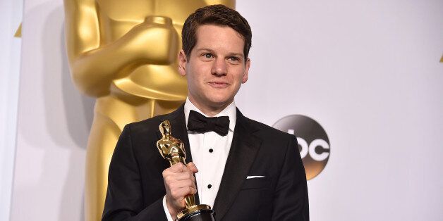 Graham Moore poses in the press room with the award for best adapted screenplay for âThe Imitation Gameâ at the Oscars on Sunday, Feb. 22, 2015, at the Dolby Theatre in Los Angeles. (Photo by Jordan Strauss/Invision/AP)