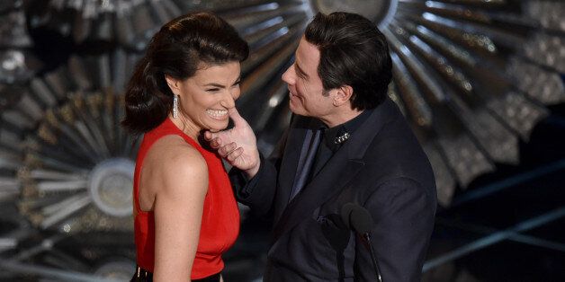 Idina Menzel, left, and John Travolta present the award for best original song at the Oscars on Sunday, Feb. 22, 2015, at the Dolby Theatre in Los Angeles. (Photo by John Shearer/Invision/AP)