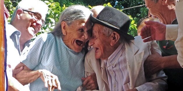 Paraguayan Anacleto Escobar (R), veteran of the Chaco War (1932-1935) fought between Paraguay and Bolivia, and his wife Cayetana Roman, smile during a ceremony coinciding with his 100th birthday in which they received a house -- the first in their lives they own -- as a gift for his merits, in Neembucu, Paraguay, on January 7, 2015. The event was organized by the governor of the state of Neembucu, Carlos Silva, to honour Escobar. AFP PHOTO / STR (Photo credit should read --/AFP/Getty Images)