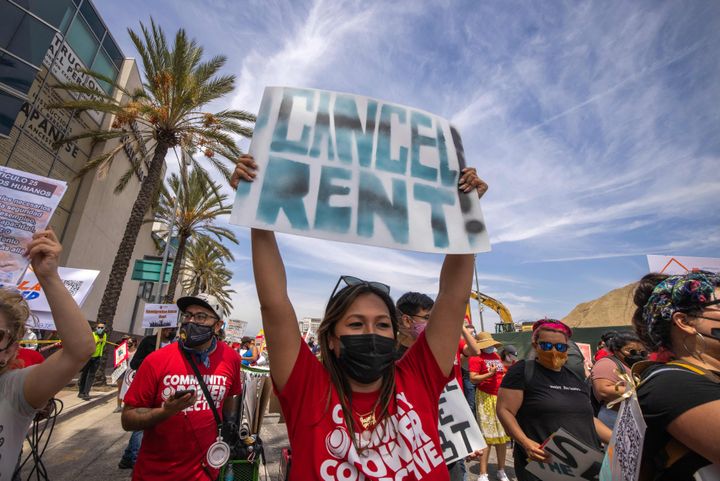 A woman calls for rent relief during a march for workers and human rights in Los Angeles on May 1. California's governor has proposed paying off qualifying residents' unpaid rent during the pandemic.