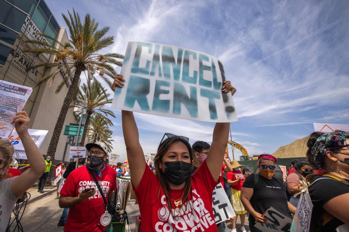 A woman calls for rent relief during a march for workers and human rights in Los Angeles on May 1. California's governor has