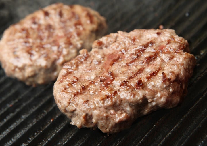 beef burgers being cooked on...