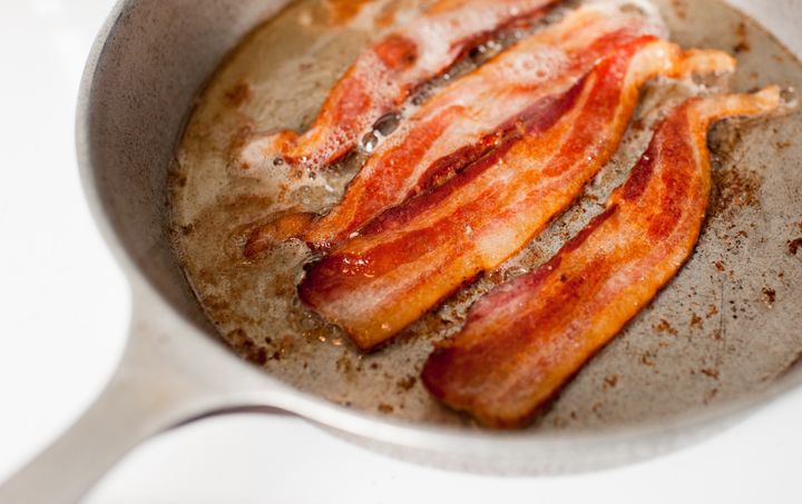 skillet with hot bacon strips