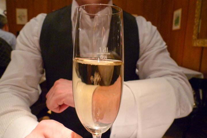 Waiter holds glass of champange