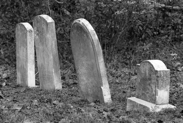 old leaning tombstones in a row.