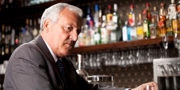 Businessman with Whiskey in Bar