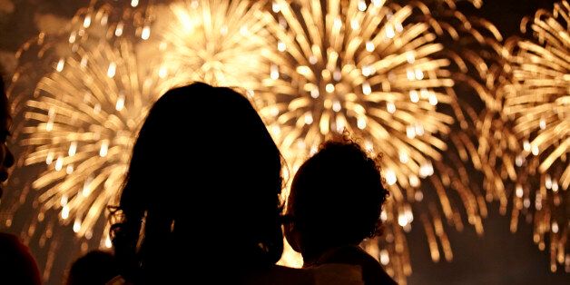 Silhouette of mother and daughter watching fireworks