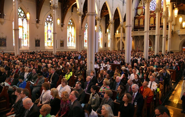 BOSTON - APRIL 18: President Barack Obama came to Boston to the Cathedral of the Holy Cross for an interfaith healing service for the victims of the Boston Marathon bombing. The audience listens. (Photo by John Tlumacki/The Boston Globe via Getty Images)