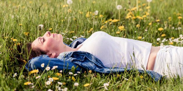 beautiful girl lying down on grass. Copy space.
