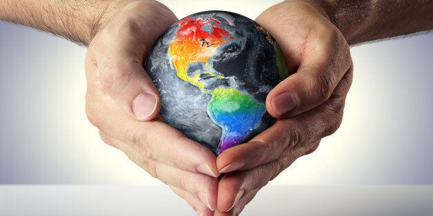 hands of two men formed a heart with the planet
