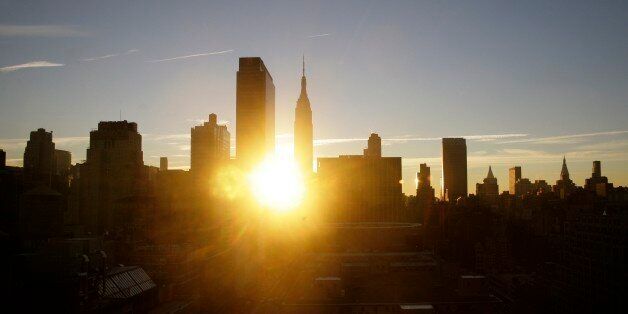 The sun rises behind the Empire State Building in New York on Thursday, Nov. 1, 2012. New York City moved closer to resuming its frenetic pace by getting back its vital subways Thursday, three days after a superstorm, but neighboring New Jersey was stunned by miles of coastal devastation and the news of thousands of people in one city still stranded by increasingly fetid flood waters. (AP Photo/Peter Morgan)