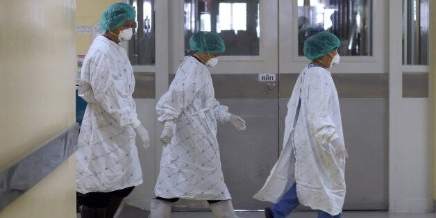 Thai hospital staff work in the isolation ward where a 75-year-old man from Oman was being treated for the Middle East Respiratory Syndrome (Mers) at Bamrasnaradura Infectious Diseases Institute in Nonthaburi province on June 19, 2015. Thailand on June 18 said a 75-year-old man from Oman was confirmed to have MERS in Southeast Asia's first case of the virus since an outbreak in South Korea that has killed 23 people. AFP PHOTO / Pornchai KITTIWONGSAKUL (Photo credit should read PORNCHAI KITTIWONGSAKUL/AFP/Getty Images)