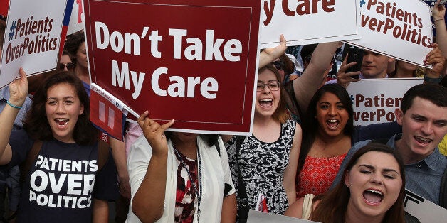 WASHINGTON, DC - JUNE 25: People celebrate in front of the US Supreme Court after ruling was announced on the Affordable Care Act. June 25, 2015 in Washington, DC. The high court ruled that the Affordable Care Act may provide nationwide tax subsidies to help poor and middle-class people buy health insurance. (Photo by Mark Wilson/Getty Images)