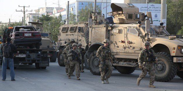 U.S. soldiers arrive at the site of a suicide attack in the heart of Kabul, Afghanistan, Saturday, Aug. 22, 2015. The suicide car bomber attacked a NATO convoy traveling through a crowded neighborhood in Afghanistan's capital Saturday, killing at least 10 people, including three NATO contractors, authorities said. (AP Photo/Massoud Hossaini)
