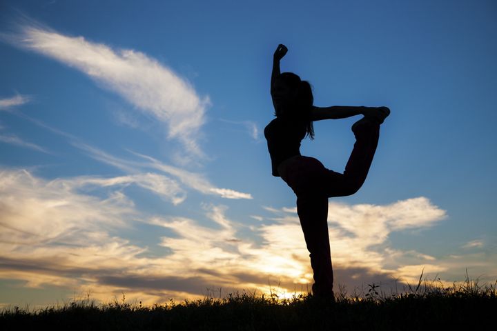 silhouette of a woman stretching