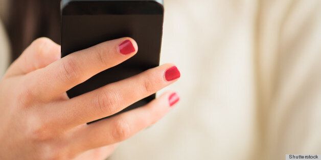 Close-up Of Woman's Hand Using Cell Phone