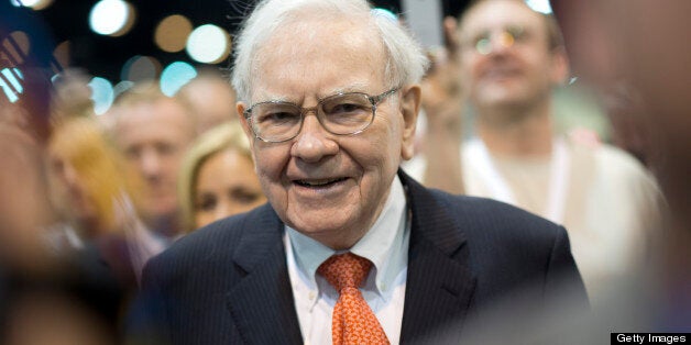 Warren Buffett, chairman and chief executive officer of Berkshire Hathaway Inc., tours the exhibition floor prior to the start of the Berkshire shareholders meeting in Omaha, Nebraska, U.S., on Saturday, May 4, 2013. Buffett's Berkshire Hathaway said first-quarter profit rose 51 percent on gains from equity-linked derivatives and insurance operations. Photographer: Daniel Acker/Bloomberg via Getty Images