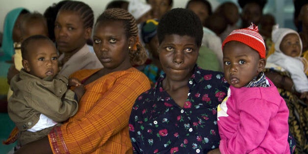 Women and children wait at the outpatient clinc as US President George W. Bush and First Lady Laura Bush tour the Meru District Hospital on February 18, 2008 in Arusha, Tanzania. The US president has used his visit -- which began in Benin on February 16, 2008, and will take him to Rwanda, Ghana and Liberia before he heads back to Washington -- to highlight US-African cooperation to battle disease and poverty. AFP PHOTO/Mandel NGAN (Photo credit should read MANDEL NGAN/AFP/Getty Images)