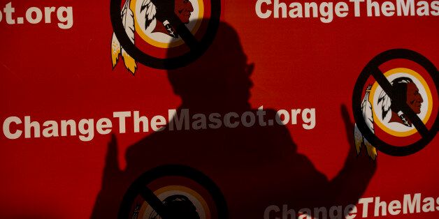 The shadow of Del. Eleanor Holmes Norton, D-D.C., is cast on the backdrop during the Oneida Indian Nation's Change the Mascot symposium, Monday, Oct. 7, 2013, in Washington, calling for the Washington Redskins NFL football team to change its name. (AP Photo/Carolyn Kaster)
