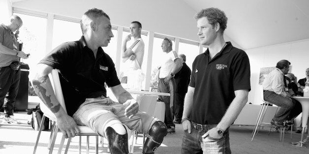 LONDON, ENGLAND - SEPTEMBER 14: (EDITORS NOTE: THIS IMAGE HAS BEEN CONVERTED TO BLACK AND WHITE) Prince Harry chats to David Birrell of the British Team at the Jaguar Landrover driving Challenge, the first event in the Invictus Games on September 9, 2014 in Gaydon, England.The International sports event for 'wounded warriors', presented by Jaguar Land Rover was an idea developed by Prince Harry after he visited the Warrior Games in Colorado USA. The four day event has brought together thirteen teams from around the world to compete in nine events such as wheelchair basketball and sitting volleyball. (Photo by Chris Jackson/Getty Images)