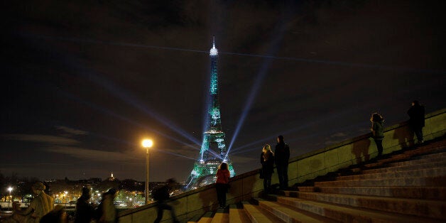 An artwork entitled 'One Heart One Tree' by artist Naziha Mestaoui is displayed on the Eiffel tower as part of the COP21, United Nations Climate Change Conference, Monday, Nov. 30, 2015. (AP Photo/Laurent Cipriani)