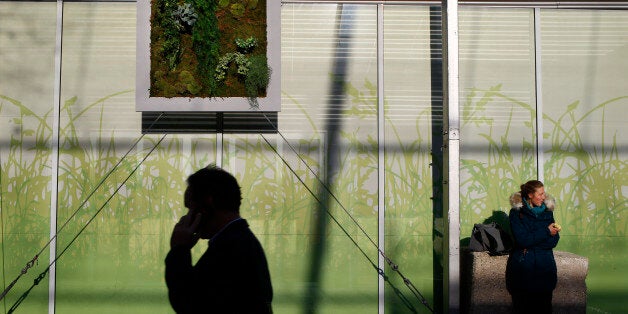 Participants walk in the alleys of the COP21, United Nations Climate Change Conference, in Le Bourget, north of Paris, Thursday, Dec. 3, 2015. (AP Photo/Francois Mori)