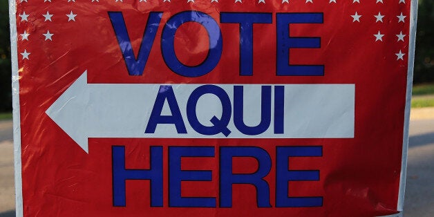 AUSTIN, TX - APRIL 28: A bilingual sign stands outside a polling center at public library ahead of local elections on April 28, 2013 in Austin, Texas. Early voting was due to begin Monday ahead of May 11 statewide county elections. The Democratic and Republican parties are vying for the Latino vote nationwide following President Obama's landslide victory among Hispanic voters in the 2012 election. (Photo by John Moore/Getty Images)