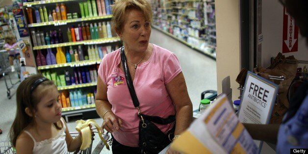 MIAMI - AUGUST 07: Linda Hoffman and her granddaughter, Riley Bulnes, 4, pick up their free prescription of antibiotics from Rosemary Petty a Publix Supermarket pharmacy technician August 7, 2007 in Miami, Florida. Publix has decided to start giving away seven commonly prescribed antibiotics for free. The oral antibiotics will be available at no cost to any customers with a prescription as often as they need it. Publix will offer 14-day supplies of the seven drugs at all of the company's pharmacies. The supermarket chain operates 684 pharmacies in five states. (Photo by Joe Raedle/Getty Images)