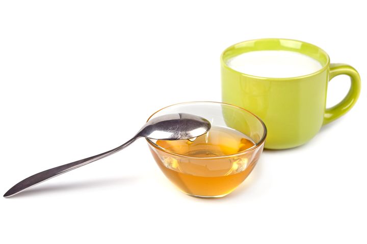 Honey and milk cup on a white background