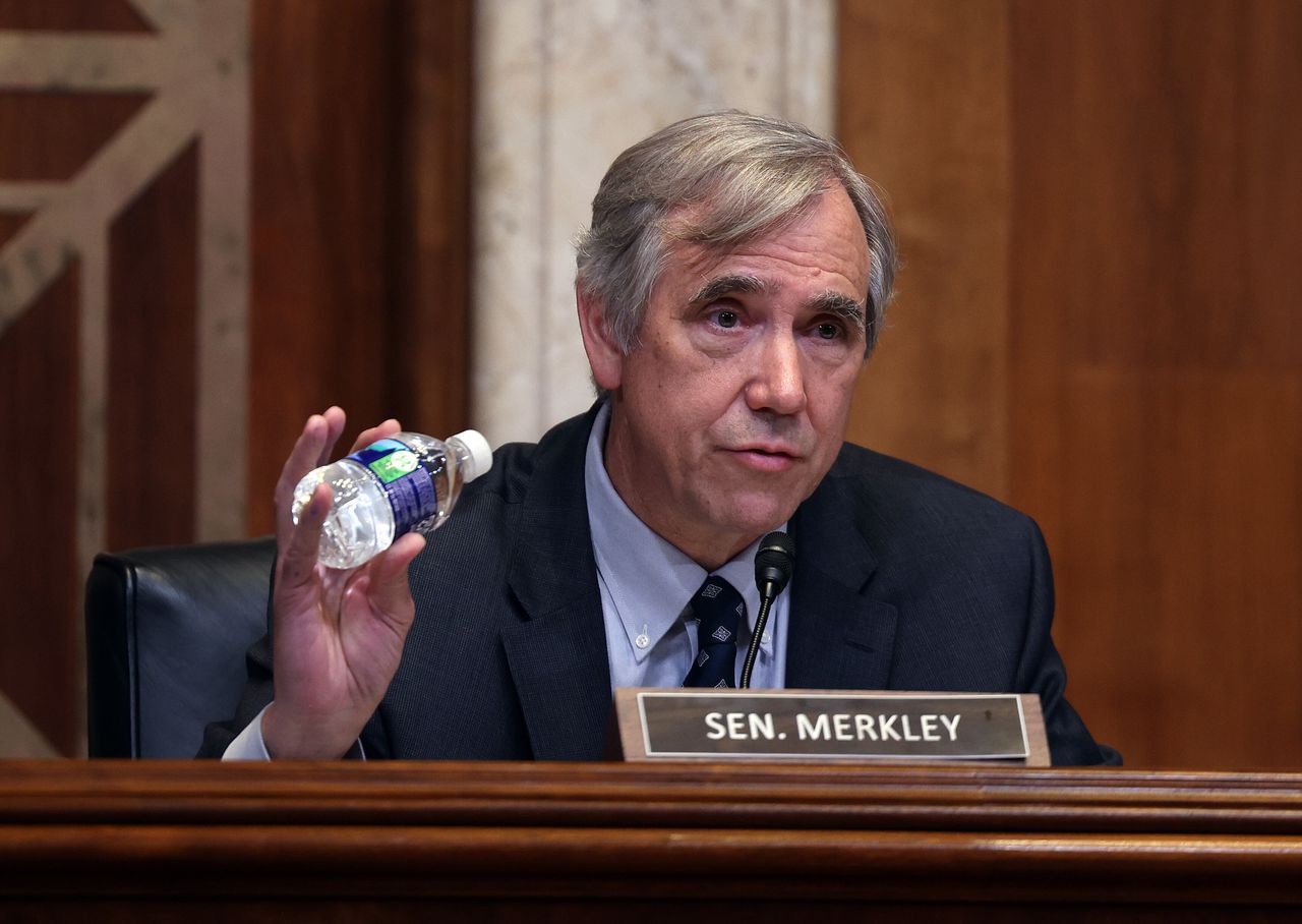 Sen. Jeff Merkley (D-Ore.) holds a plastic bottle as he talks about recycling during a Senate Appropriations Committee subcommittee hearing on June 9, 2021.