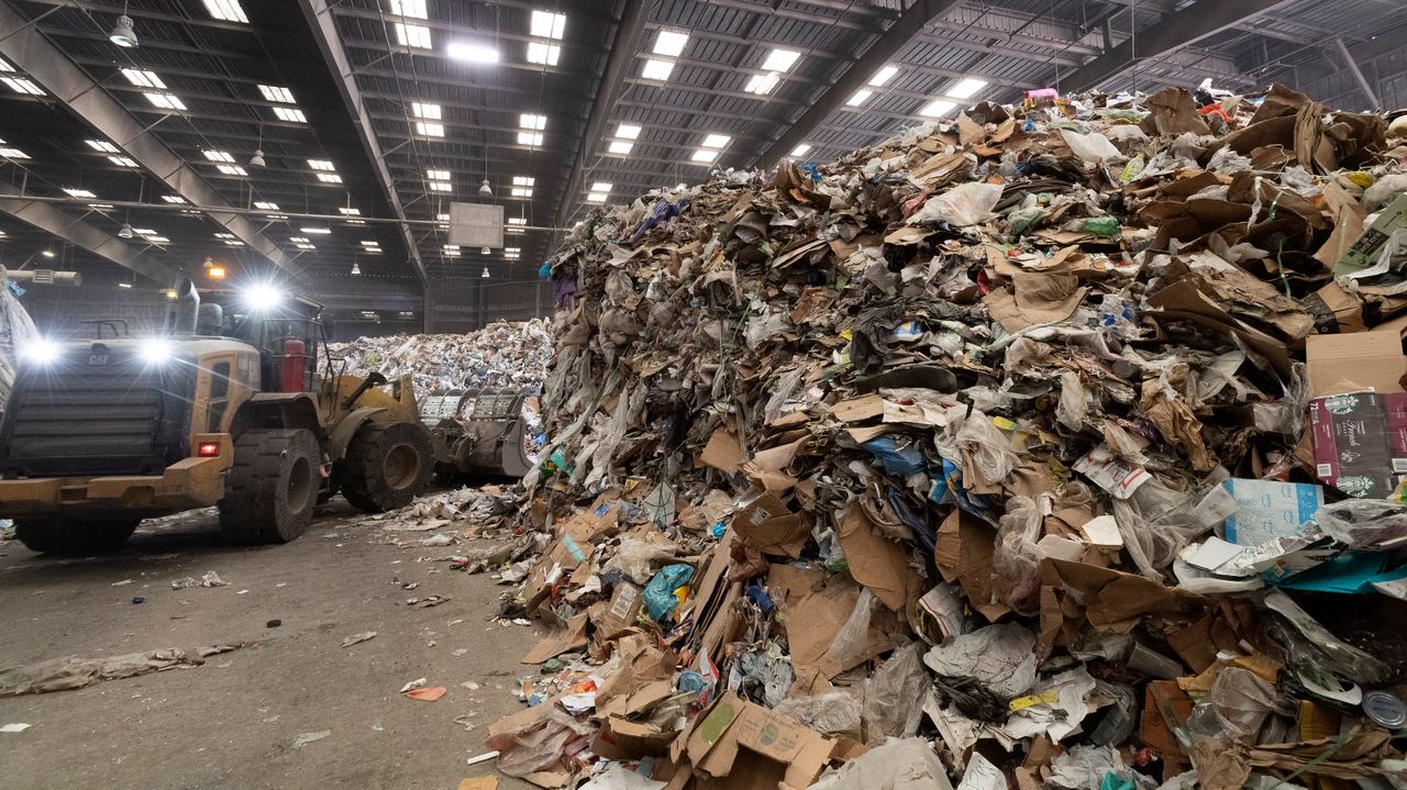 Heavy machinery moves material on the tip floor, where trucks dump their contents before waste is sorted at Republic Services in Anaheim, California, on April 15, 2021. 