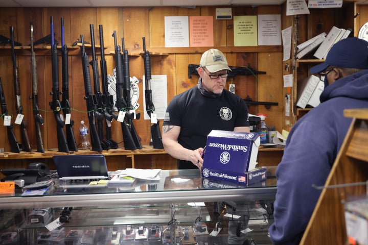 A customer is assisted with a gun purchase at a store in Tinley Park, Illinois. About 42% of last year's gun sale denials were because the would-be buyers had felony convictions on their records.