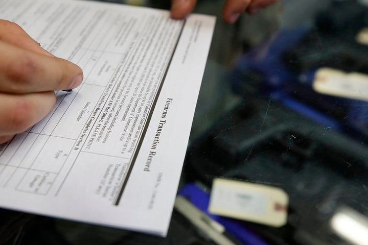 A customer fills out a background check form at a store in Orem, Utah. More than 300,000 people were prevented from purchasing a gun last year after completing a background check.