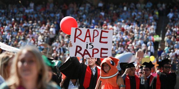 Paul Harrison holds a sign that reads: "Rape is rape", during the Wacky Walk portion of the Stanford University commencement ceremony in Palo Alto, California, U.S. June 12, 2016. REUTERS/Elijah Nouvelage