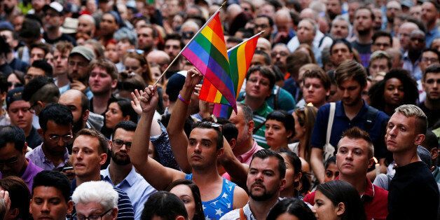 People gather during a vigil outside The Stonewall Inn remembering the victims of the Orlando massacre in New York, U.S., June 13, 2016. REUTERS/Shannon Stapleton