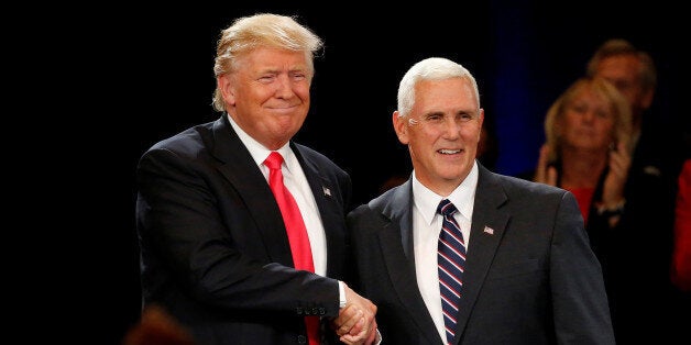 Republican presidential candidate Donald Trump (L) and vice presidential candidate Mike Pence attend a campaign event in Roan