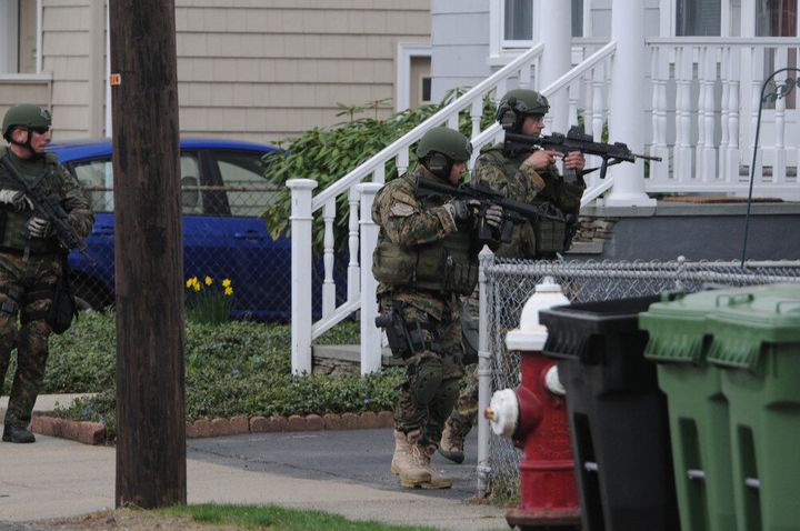 WATERTOWN - APRIL 19: Police conduct a door-to-door search for 19-year-old Boston Marathon bombing suspect Dzhokhar A. Tsarnaev on Brimmer Street April 19, 2013 in Watertown, Massachusetts. After a car chase and shoot out with police, one suspect in the Boston Marathon bombing, Tamerlan Tsarnaev, 26, was shot and killed by police early morning April 19, and a manhunt is underway for his brother and second suspect, 19-year-old Dzhokhar A. Tsarnaev. The two men are suspects in the bombings at the Boston Marathon on April 15, that killed three people and wounded at least 170. (Photo by Darren McCollester/Getty Images)