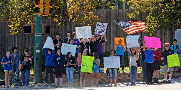 LITTLETON, CO - SEPTEMBER 24: Student walk-outs in Jefferson County continued for the third straight day after students from Chatfield High School and Dakota Ridge High School left classes in protest of school board decisions and proposals, September 24, 2014. Students for the two schools joined together, at the corner of Ken Caryl and Chatfield Blvd. in Littleton, to wave sings. (Photo by RJ Sangosti/The Denver Post via Getty Images)