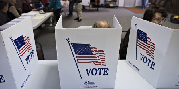 Voters cast their ballots in the U.S. midterm election at the Red Oak Fire Department in Red Oak, Iowa, U.S., on Tuesday, Nov. 4, 2014. In Iowa, where Republican Joni Ernst and Democrat Bruce Braley are in a close Senate race, more than 431,000 had already cast ballots by the end of the weekend with total voting expected to exceed 1.1 million. Photographer: Daniel Acker/Bloomberg via Getty Images