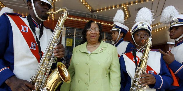 Former Frederick Douglass High School principal Isabelle Grant poses with the high school band outside of the Silver Theater, in Silver Spring, Md., on Friday, June 20, 2008, for the screening of the documentary, "Hard Times at Douglass High: A No Child Left Behind Report Card," which premieres June 23 on HBO. (AP Photo/Jose Luis Magana)