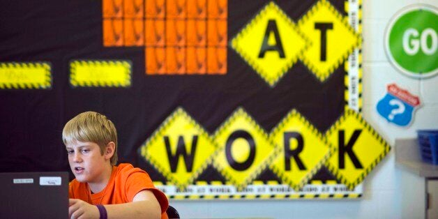 In this photo taken Feb. 12, 2015, sixth grader Alex Greuey, 11, reads through a problem in the English Language Arts section of the PARCC (Partnership for Assessment of Readiness for College and Careers) test as he and his classmates practice for the Common Core State Standards Exams at Morgan Elementary School South in Stockport, Ohio. On Tuesday, Ohio becomes the first state to administer one of two tests in English language arts and math based on the Common Core standards developed by two separate groups of states. By the end of the year, about 12 million children in 28 states and the District of Columbia will take exams that are expected to be harder than traditional spring standardized state tests they replace. In some states, they'll require hours of additional testing time students will have to do more than just fill in the bubble. The goal is to test students on critical thinking skills, requiring them to describe their reasoning and solve problems. (AP Photo/Ty Wright)