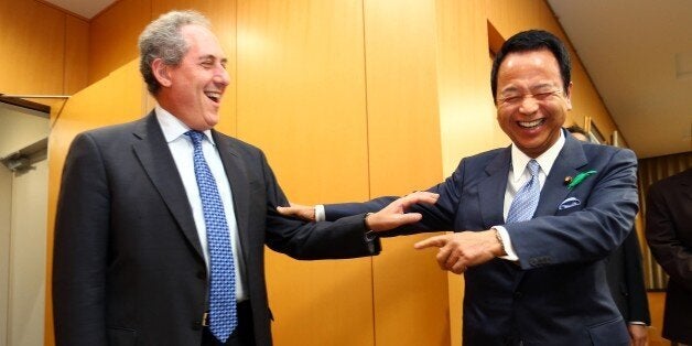 US Trade Representative Michael Froman (L) is greeted by his Japanese counterpart Akira Amari (R) prior to their talks over deadlocked Trans-Pacific Partnership (TPP) negotiations, at Amari's office in Tokyo on April 19, 2015. The Trans-Pacific Partnership is a trade framework negotiated between Australia, Brunei, Canada, Chile, Japan, Malaysia, Mexico, New Zealand, Peru, Singapore, the United States and Vietnam. AFP PHOTO / POOL (Photo credit should read STR/AFP/Getty Images)