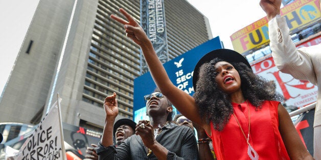 TIMES SQUARE, NEW YORK, UNITED STATES - 2015/08/13: Janelle Monae (right), a singer with Wondaland, gestures after calling out the name of one of the victims of police brutality mentioned in the song 'Hell You Talmbout.' Members of the Stop Mass Incarceration Network held a rally in Times Square with Wondaland performers, including recording artists Jidenna and Janelle Monae, who performed their new protest song 'Hell You Talmbout.'. (Photo by Albin Lohr-Jones/Pacific Press/LightRocket via Getty Images)