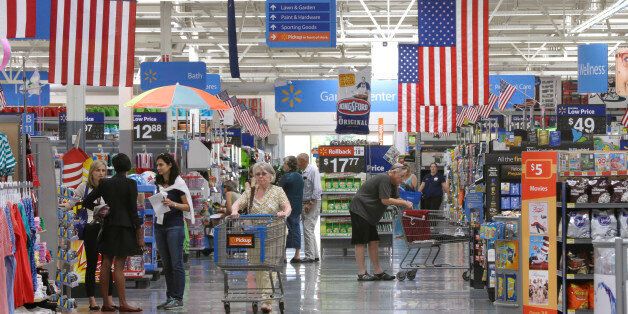 Customers shop on widened aisles at a Wal-Mart Supercenter store in Springdale, Ark., Thursday, June 4, 2015. (AP Photo/Danny Johnston)