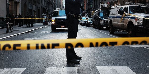 NEW YORK, NY - NOVEMBER 09: Police stand at the scene of a midtown shooting that left one dead with two others wounded on November 9, 2015 in New York City. A 43-year-old man was shot and killed in the morning shooting inside a subway station at Eighth Avenue and 35th Street in Manhattan, near Pennsylvania Station. Police are put up crime stoppers posters and are searching for the gunman and two other men. (Photo by Spencer Platt/Getty Images)